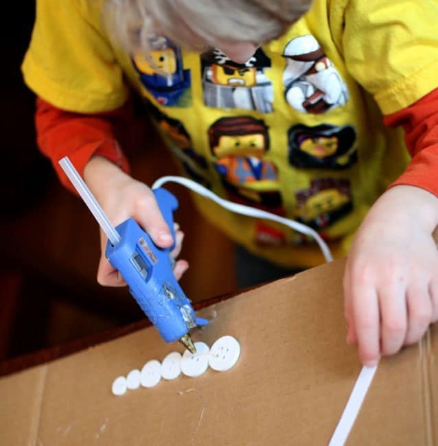 Hot glue the buttons to the ribbons for your creative winter craft for kids!