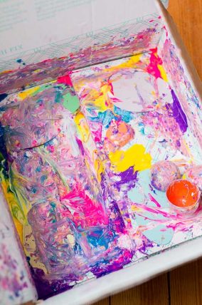 Add paper cutouts, hard plastic toys, and blobs of paint to a box - close up and shake!