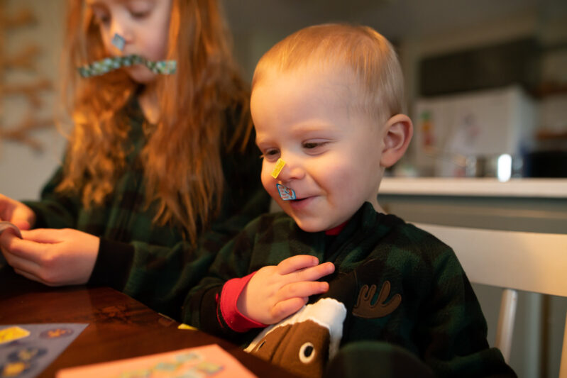 Toddlers being silly with stickers activity.