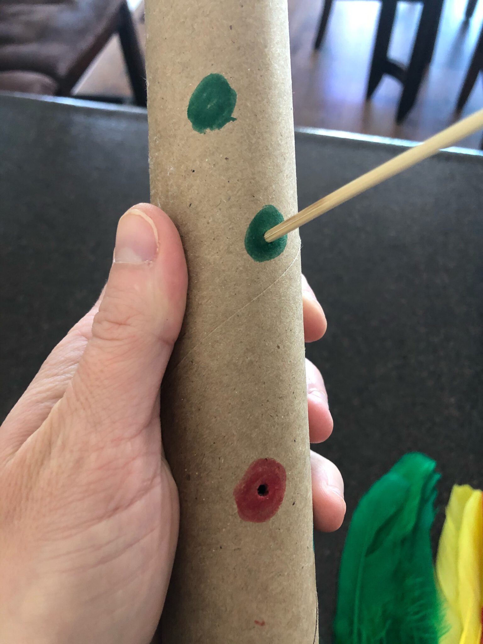 Poking holes in paper towel roll