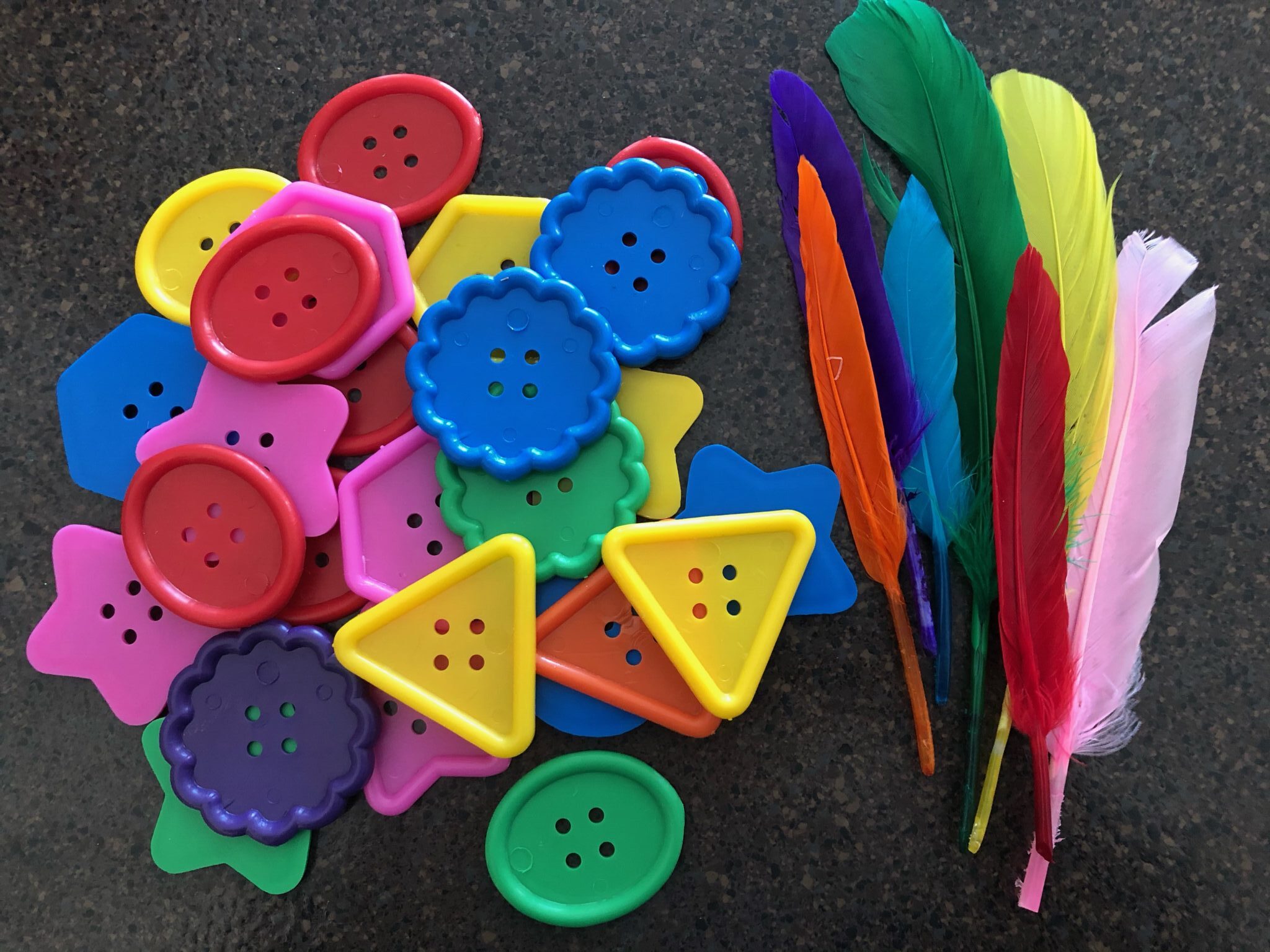 A simple and fun color matching fine motor activity with buttons and feathers.