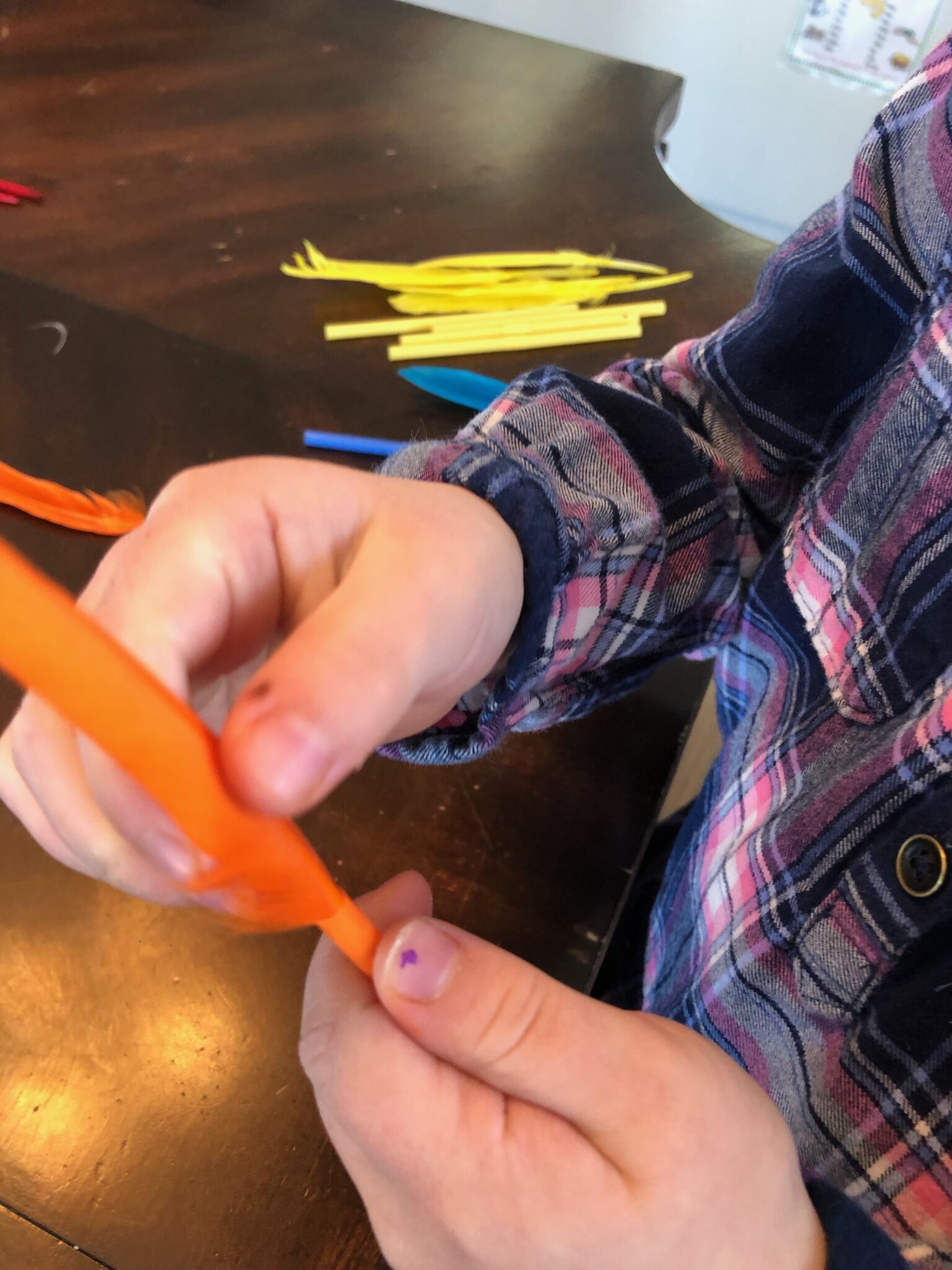 Threading feathers into straws