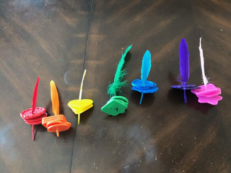 A simple and fun color matching fine motor activity with buttons and feathers.