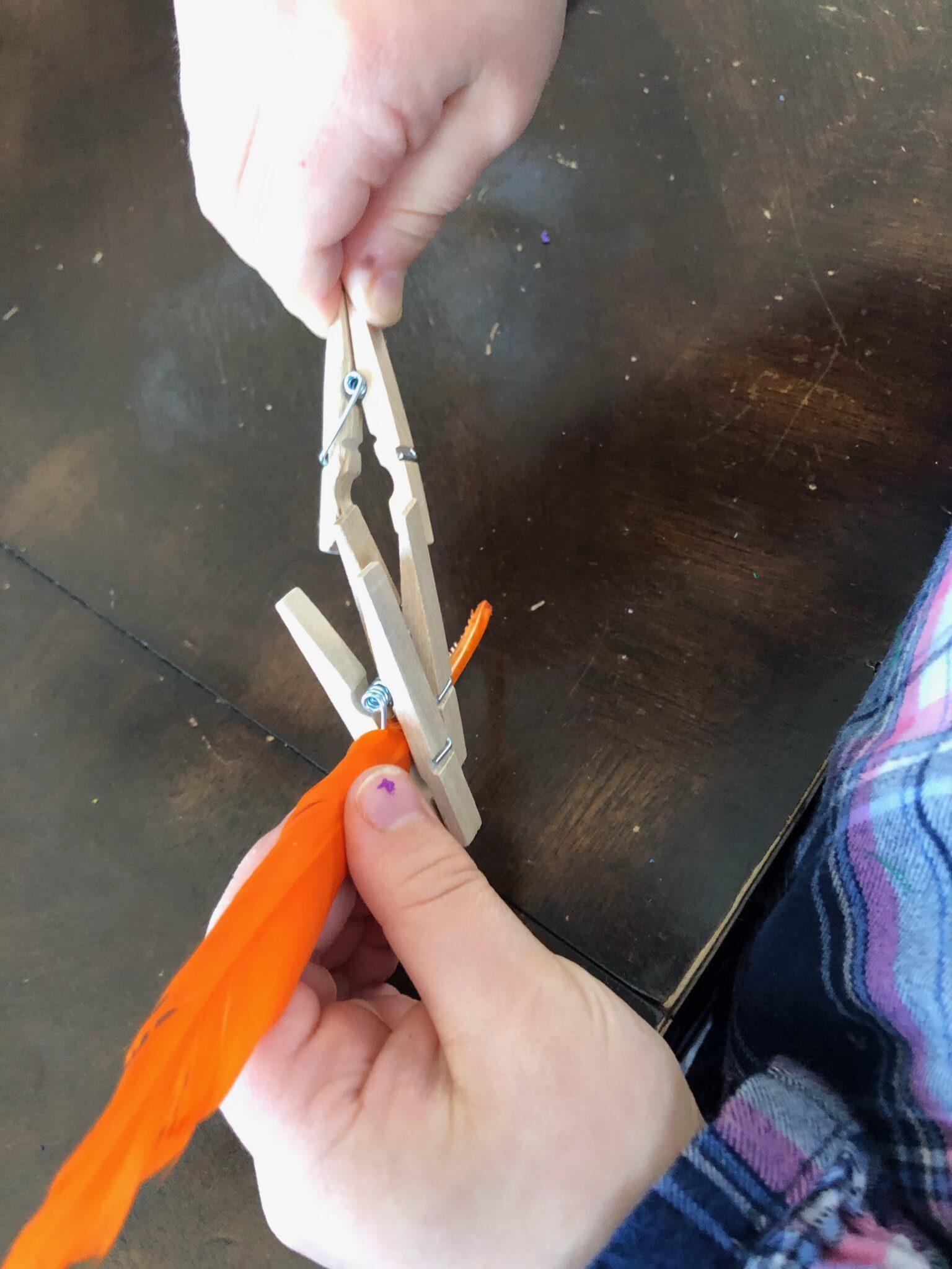 Feathers and clothespins are perfect for fine motor activity exploration.