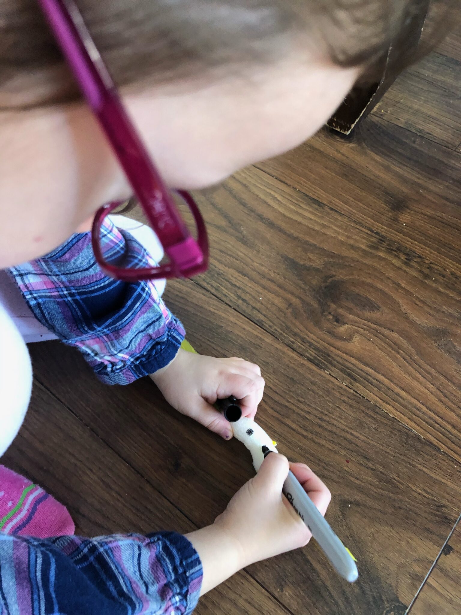 Drawing eyes on a packing peanuts bird craft