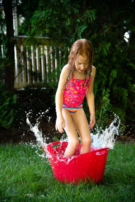 Beat the heat this summer with a simple fun DIY backyard water obstacle course using household supplies for your kids to cool down outside. 