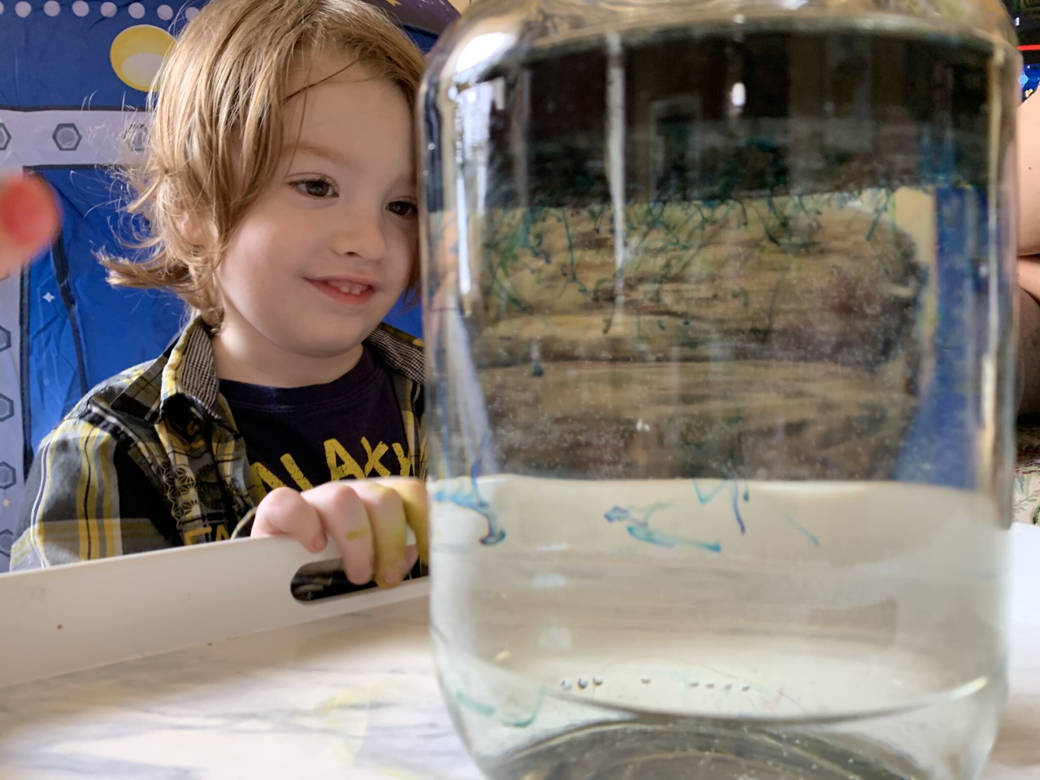 Create a galaxy of shooting stars in a jar space experiment for kids to do at home using simple household supplies from the kitchen!