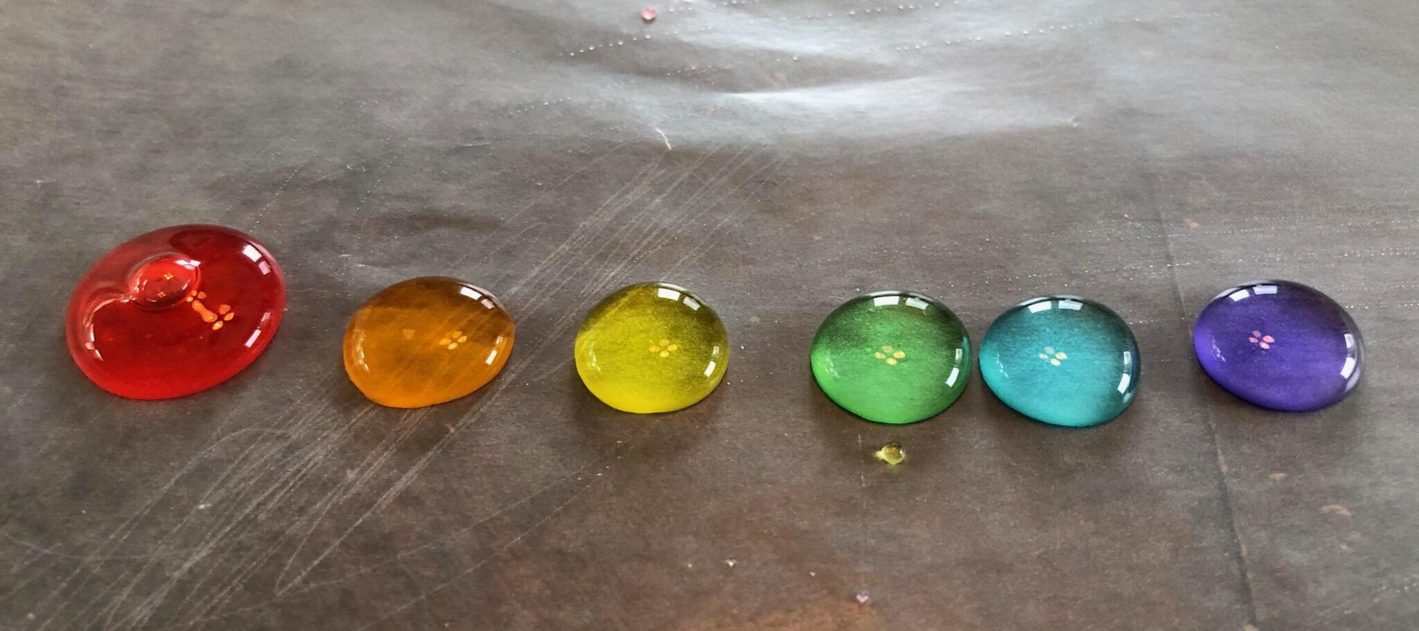 drop painting with colored water on wax paper