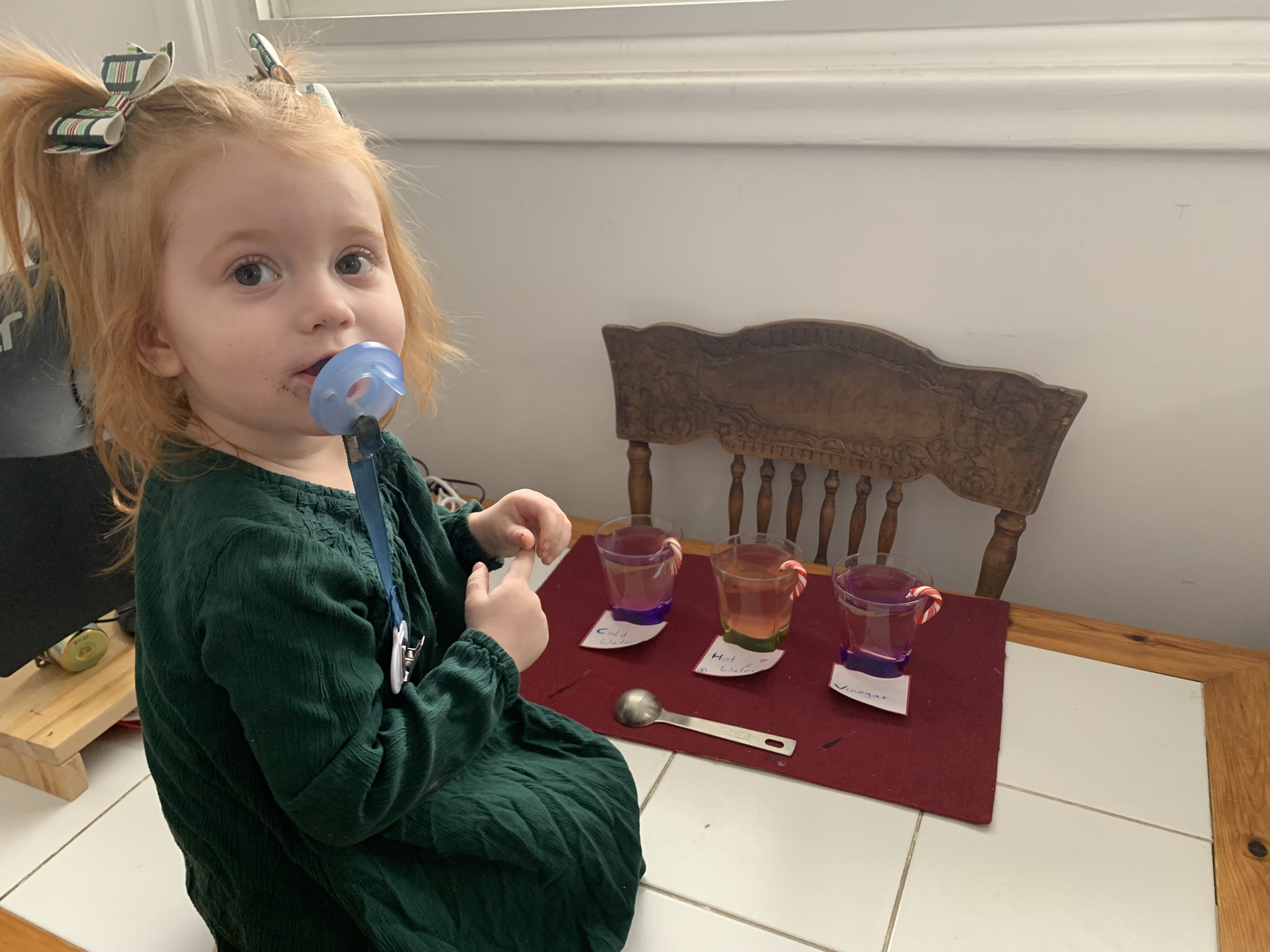 Maisie is thrilled to be second to see her candy cane dissolve.